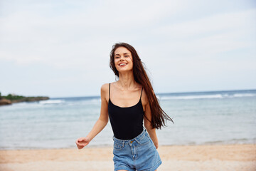 Fototapeta na wymiar woman running positive young travel sea beach smile summer sunset lifestyle