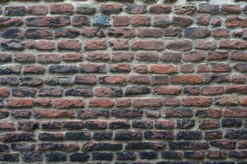 A wall with old ancient bricks and cement, suitable for background image usage