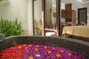 Frangipani petals and flowers in the bathtub, spa weekend, wellbeing, body care and beauty concept	