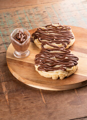 chocolate cream waffle with hazelnut and white chocolate on wooden board on rustic table portrait