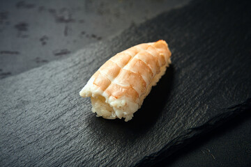Nigiri Sushi with shrimp on dark background. Sushi menu. Japanese food.