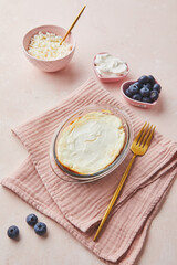 Delicious cottage cheese casserole in portioned glass forms with sour cream. Traditional Russian cuisine for breakfast - Zapekanka.