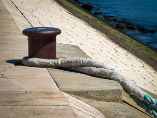 Bollard and rope waiting to be needed or hoping to be needed
