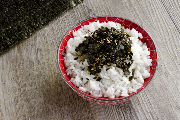 Rice with vegan furikake seasoning with torn nori seaweed on a top. © Fotema