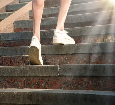 Feet in sneakers going up the stairs