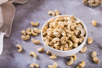Dried cashew nuts in a bowl on the table for a vegetarian diet