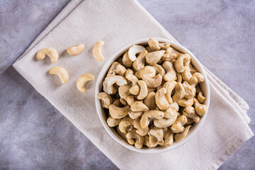 Close up of delicious dried raw cashews in a bowl on the table for a plant based diet top view