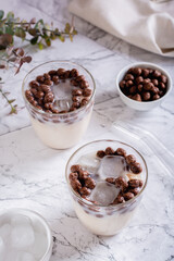 Homemade milk bubble tea with ice in glasses on the table vertical view