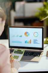 Seen from behind modern female working with charts