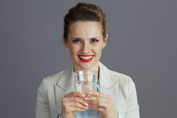 smiling 40 years old woman employee in light business suit