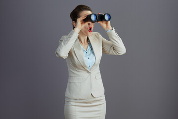 surprised trendy woman worker in light business suit