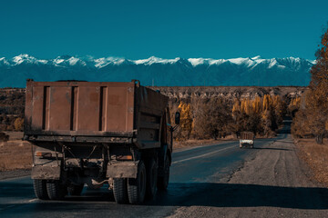 Old trucks on a road in the mountains