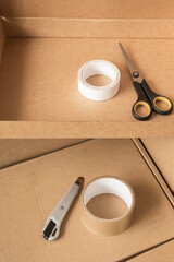 boxes for moving and delivery as well as scotch tape and an office knife with scissors