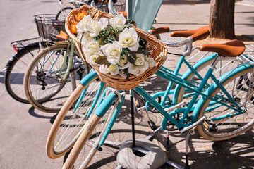 Close-up of vintage turquoise bicycle with flowers