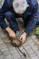 A man is a professional, an electrician, an electromechanic repairs an electric motor. Photography, portrait.