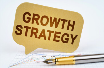 On the business diagram is a pen and a sign with the inscription - Growth Strategy
