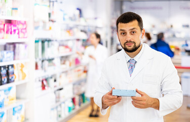 Portrait of male pharmacist working in modern farmacy