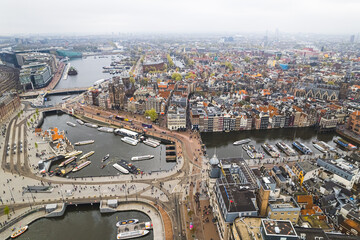 Obraz premium scenic drone shot of Amsterdam City center, canals with colorful houses, harbor and houses. High quality photo