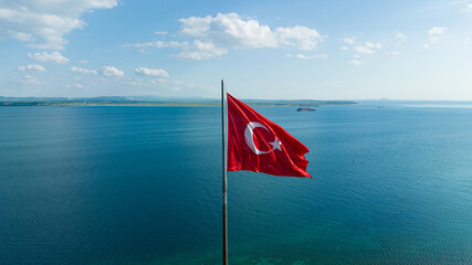 Turkish flag. Red Turkish flag waving on the sea.