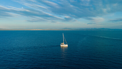 Fototapeta premium Boat moving on the sea. Sailing boat on the sea at sunset