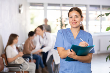 Woman doctor wear white medical uniform and stethoscope with folder of documents in clinic