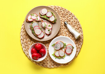 Obraz na płótnie Canvas Plates with delicious radish bruschettas on yellow background