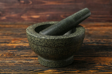 Mortar and pestle on wooden background