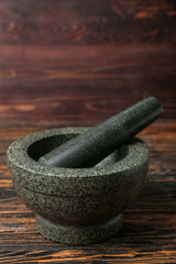Mortar and pestle on wooden background