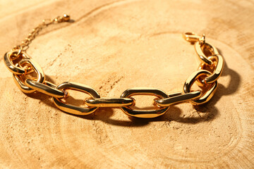 Beautiful chain bracelet on wooden background