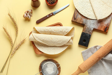 Boards with ingredients for preparing lavash on beige background