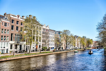 Amsterdam, Netherlands - March 28, 2023: Iconic houses along the streets and canals of Amsterdam
