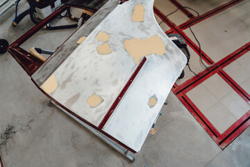 The car body after the accident is covered with putty, primer before painting. The process of...