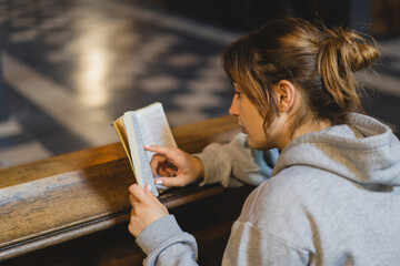 Christian woman reading bible in an ancient Catholic temple. Reading the Holy Bible in temple....