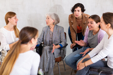 in group lesson, female middle-aged students are animatedly discussing ways to perform practical course work. Practical application of acquired knowledge