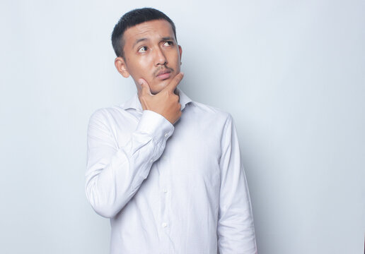 Adult Asian man wearing white shirt showing thinking gesture
Keywords: