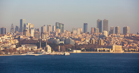 Naklejka premium Scenic view of modern cityscape of Beyoglu district in Istanbul from Topkapi across Bosphorus and Golden Horn bay on sunny winter day, Turkey.