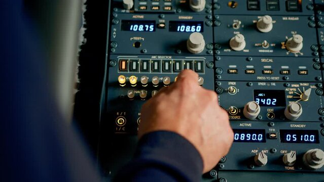 The captain presses the buttons on the control panel to start the engine of the plane flight Up close flight simulator