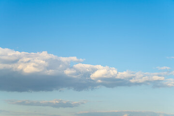 A blue sky with clouds and a white cloud