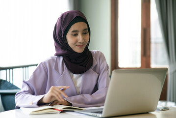 Muslim business woman working in the office Analyzing a business and making a business plan business concept