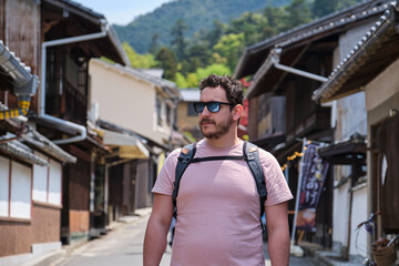 European tourist visiting a traditional japanese street in Miyajima, Hiroshima, Japan.