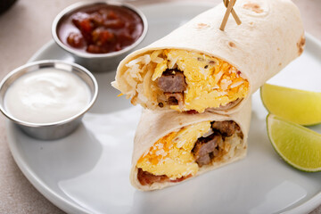 Breakfast burritos with scrambled eggs, sausage, cheese and potatoes