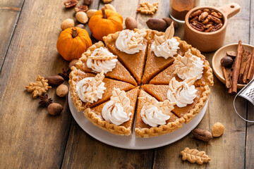 Fototapeta na wymiar Traditional pumpkin pie for Thanksgiving with whipped cream