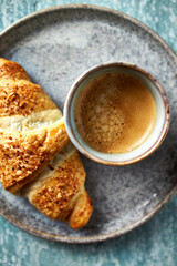 Cup of coffee with croissant. Top view. Close-up