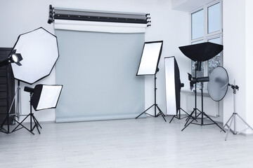 Interior of modern photo studio with professional lighting equipment