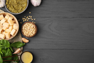 Different ingredients for cooking tasty pesto sauce on grey wooden table, flat lay. Space for text