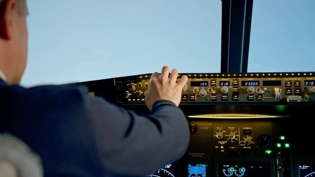 Commercial aircraft pilot adjusts aircraft flight parameters during high altitude flight View from inside the cabin