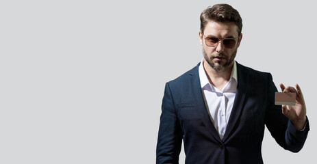 A man with a credit card has access to a line of credit purchases or pay bills. Credit cards offer purchases. Credit score concept. Banner for header, copy space. Poster for web design.