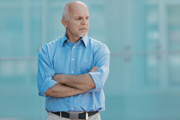 Blue tones, glass, man thinking with downward gaze