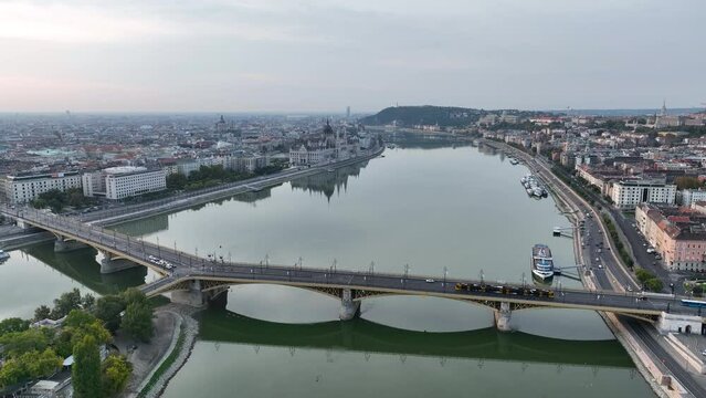 Establishing Aerial View Shot of Budapest, Hungary at sunrise. Margaret Bridge or Margit hid over River Danube, embankment. Public transport in the city