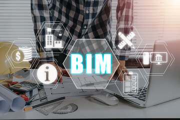 BIM, Building Information Modeling Technology concept, Engineering man working on desk with Building Information Modeling icon on virtual screen.